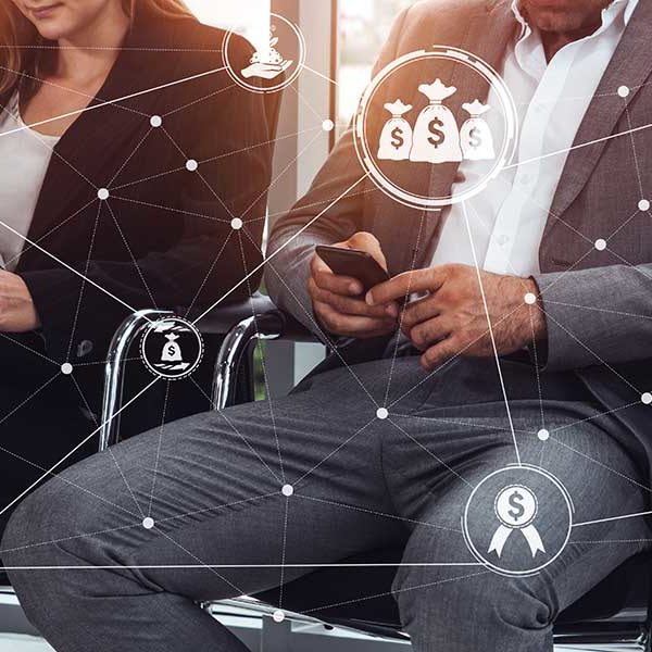 People sitting in chairs, using their smartphones, with overlay graphics representing financial concepts like dollar signs and piggy banks, highlighting the interconnected nature of FinTech systems. The connected dots suggest an overview of a digital financial transaction network enabled by advanced financial technology.