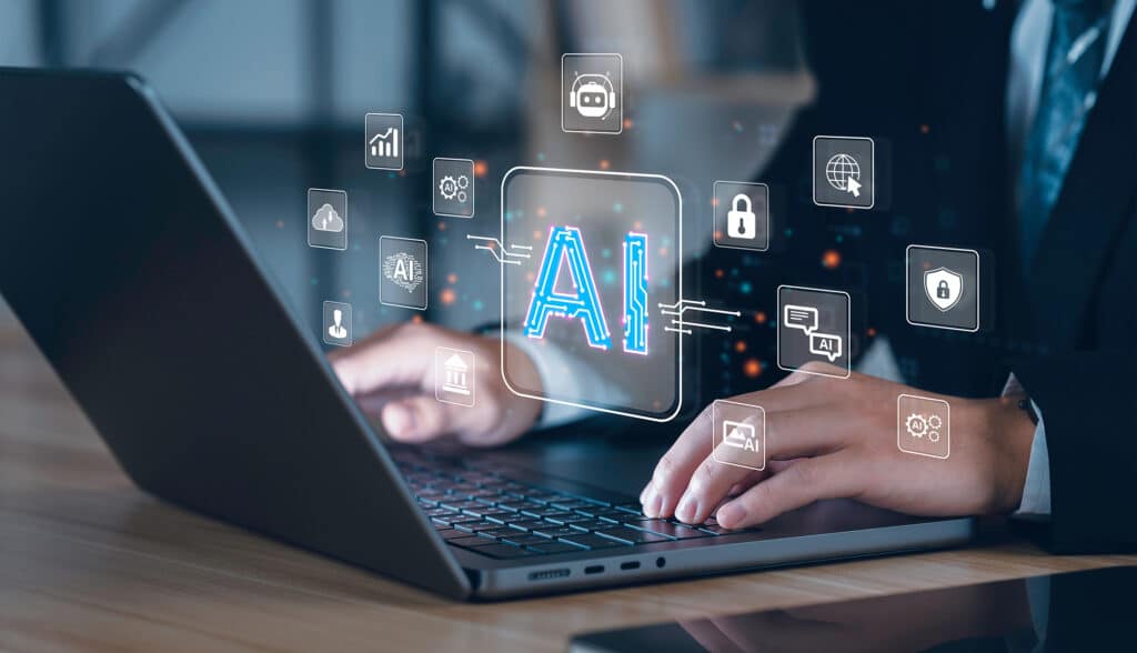 A person is working on a laptop with floating holograms symbolizing various technology concepts such as AI, data, cloud computing, and security. The main focus is on a glowing "AI" icon at the center, exuding a sense of business power. The background is slightly blurred and professional.